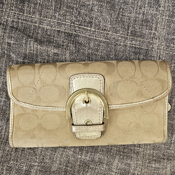 Coach Handbags - Vintage Coach Soho Signature Flap Buckle Snap Bifold Wallet in gold metallic.